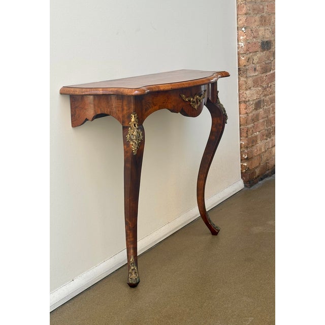 This Louis XV wall console is beautifully made with well executed cabriole legs mounted with brass “chabottes” and it has...