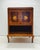 Classic TV cabinet with an elegant appearance, likely in the style of an 18th- or 19th-century European marquetry cabinet....