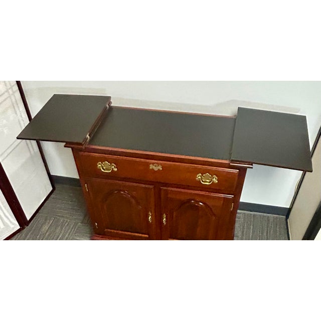 Mahogany flip top server/Bar Cabinet by The Colonial Furniture Company. The top opens to an expanded serving surface, the...