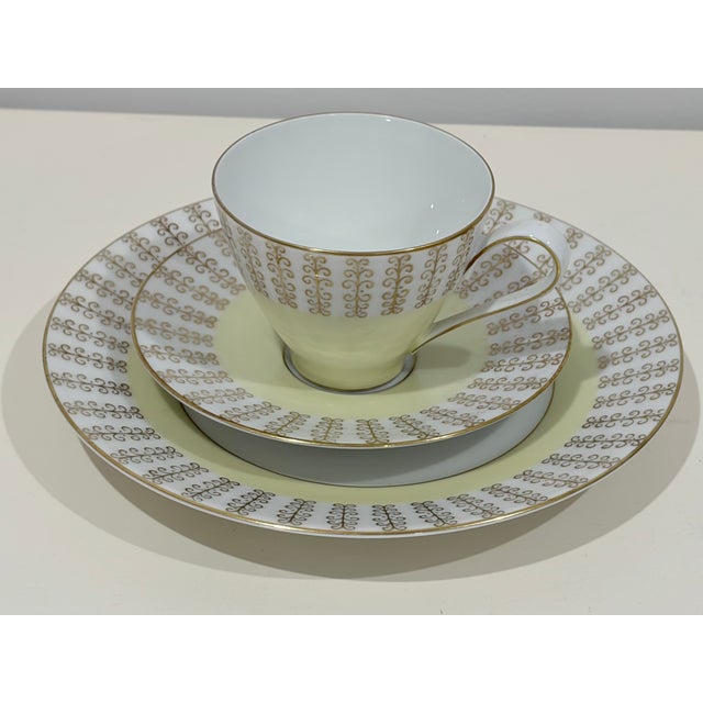 This 3-piece set by Rosenthal Germany includes a tea cup, saucer, and small plate, all featuring a wide pale yellow band...