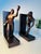A striking pair of modern abstract figural bookends featuring sculptural human forms in dynamic poses. The stylized...