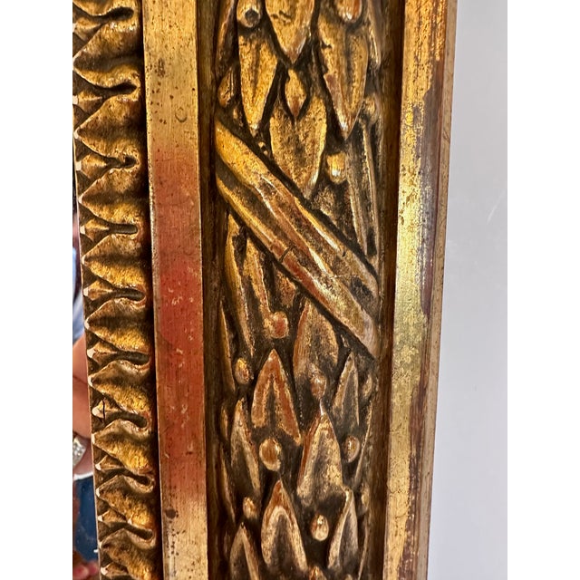 French Neoclassical wall mirror with beautifully detailed gilded frame. Mirror 19” W x 31” H