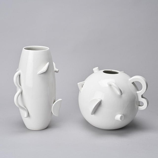 A set of two postmodern white porcelain vases by Alessandro Mendini for Zanotta, known as the "Dealbata" collection. We...