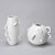 A set of two postmodern white porcelain vases by Alessandro Mendini for Zanotta, known as the "Dealbata" collection. We...