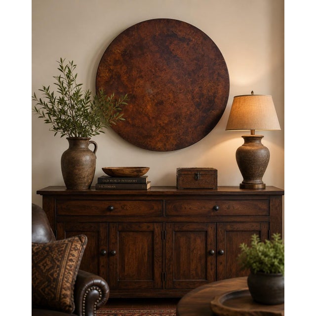A striking oversized decorative wall charger crafted in India, featuring a richly mottled copper, bronze, and deep brown...