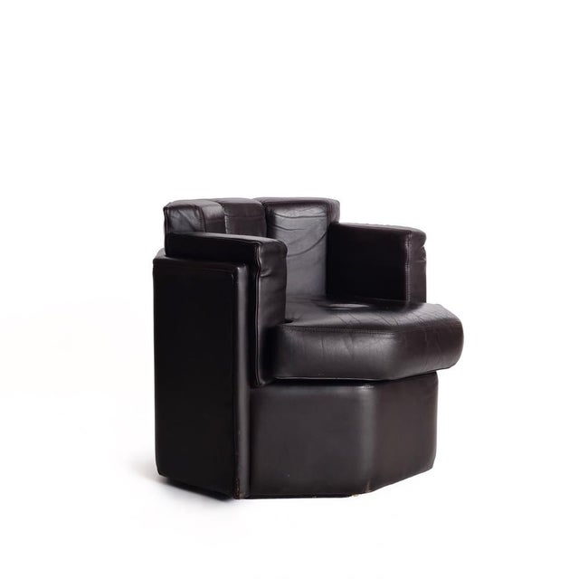 Brown octagonal solid club chairs. The original segmented way of reupholstery makes these club chair both rare and unique...