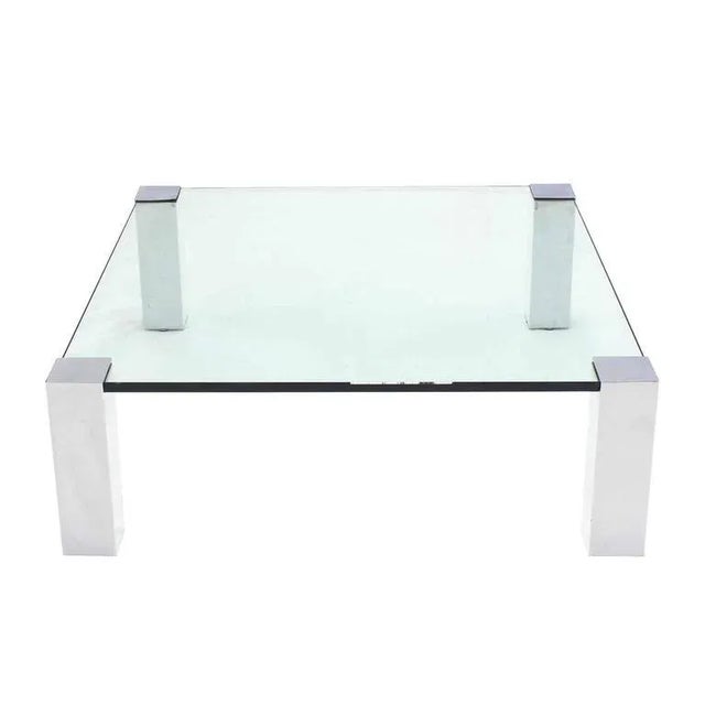 Very nice square coffee table with thick glass top and chrome legs. Measures: 41 x 41.