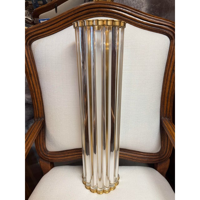 Gorgeous solid brass wall sconce fashioned with thick tubular glass rods built into the frame. The glass rods are inserted...