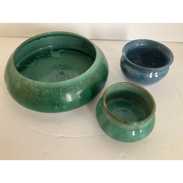 This set of three arts and crafts pottery pieces are pottery studio made and craft in rich colors. They were purchased at...