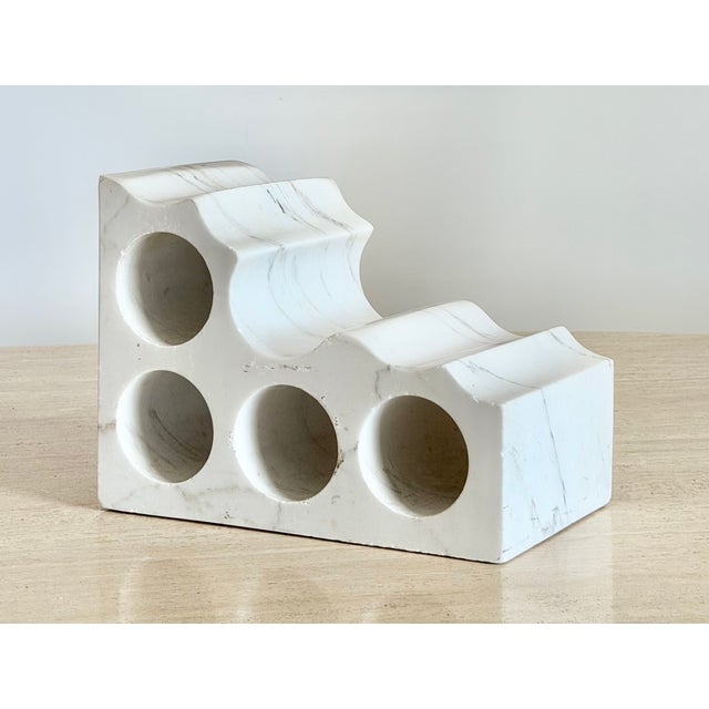 A solid, carved marble bottle display. This über heavy, block of marble with four carved cylindrical openings to display...