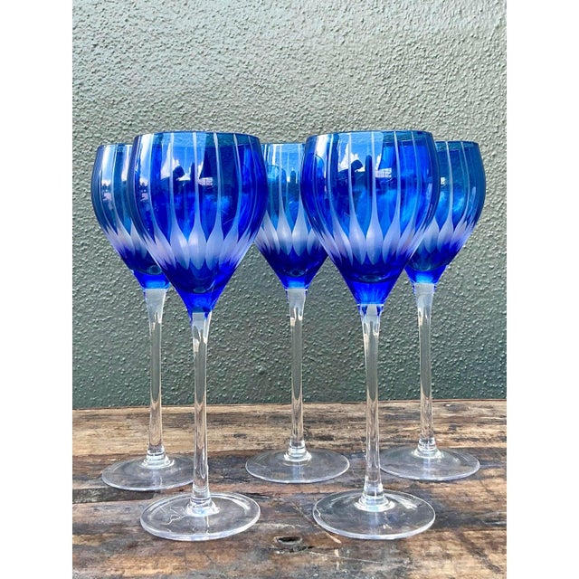 Add a dramatic flourish to your dining table with this statuesque set of five vintage cut-to-clear crystal goblets....