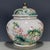 A beautiful Chinese Famille Rose porcelain covered jar. The white ground is finely hand-painted with a vibrant scene of...