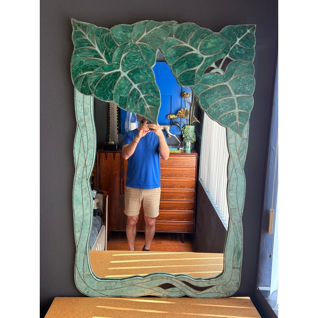 Tessellated green stone and jade monstera leaf wall mirror with brass trim in the manner of Maitland Smith