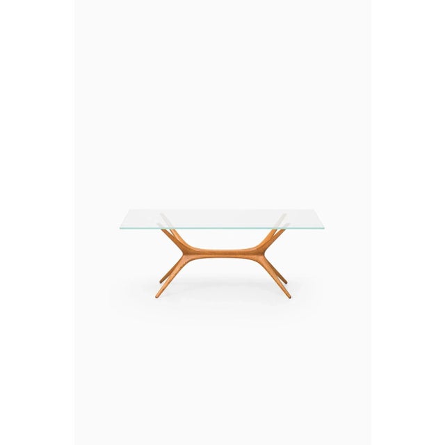 This model 9020 oak coffee table with glass top was designed by Tapio Wirkkala and produced by Asko in Finland in 1958....