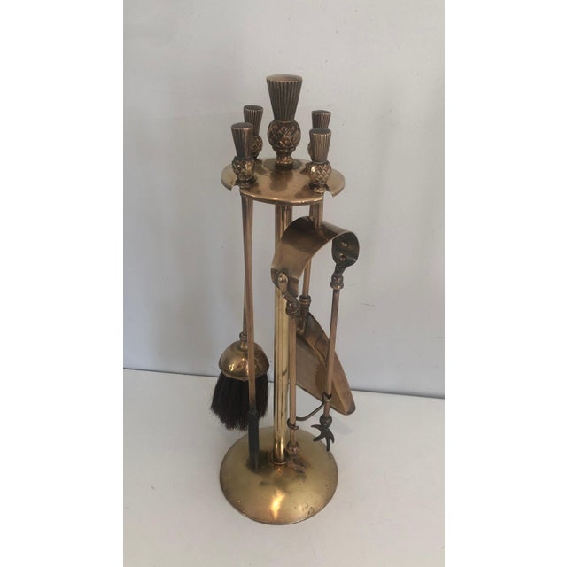 This neoclassical-style pineapple-shaped fireplace tool is made of brass. It is a work in the style of the famous French...