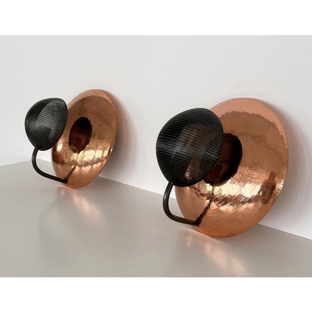 Beautiful and particular pair of wall sconces, made of hammered copper and perforated black metal. Made in Italy in the...