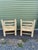 Vintage lounge chairs featuring a sculptural bobbin-style carved wood frame finished in a distressed, crackled patina that...