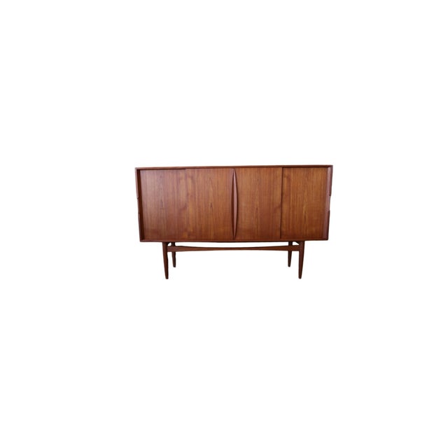 An elegant Danish teak cabinet with four sliding doors, exclusive interior and timeless design from Scandinavian...