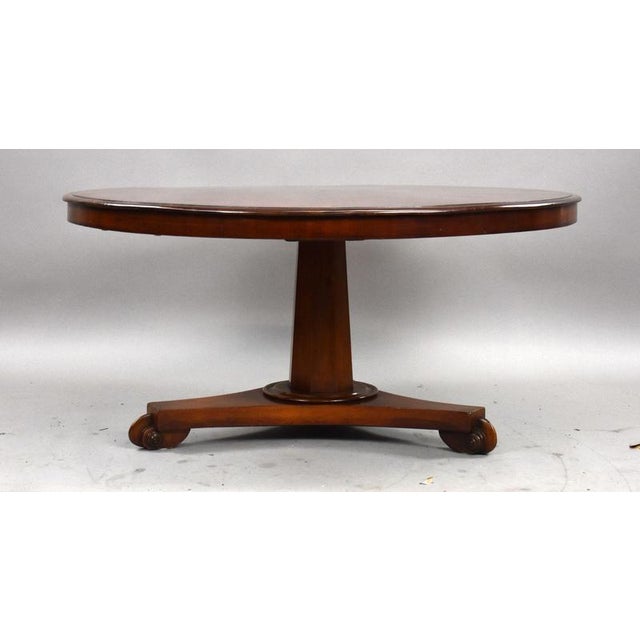 A good quality Victorian mahogany coffee table, featuring a circular top with a moulded edge, raised on a substantial...