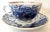 This Russian cup and saucer have been hand painted with swirls of blue with gold accents.