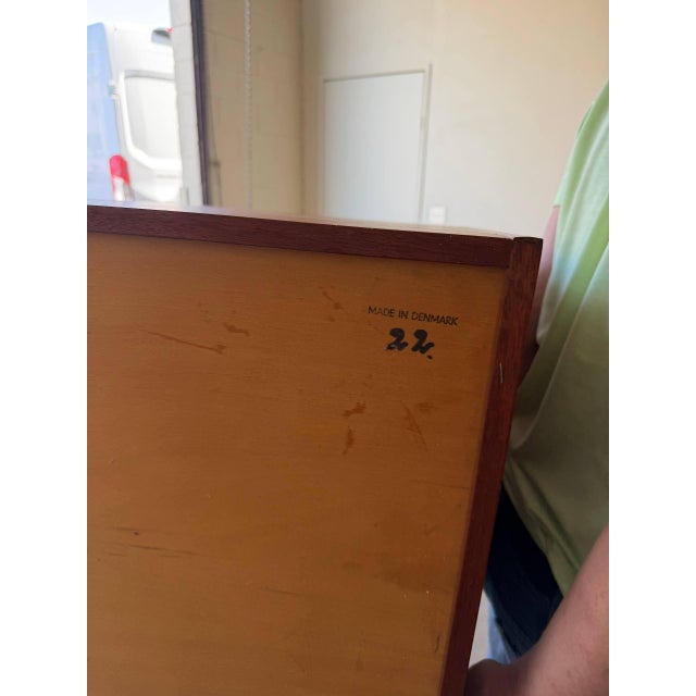 Vintage Danish Mid-Century Modern cabinet crafted in beautifully grained teak, featuring a clean, minimalist silhouette...