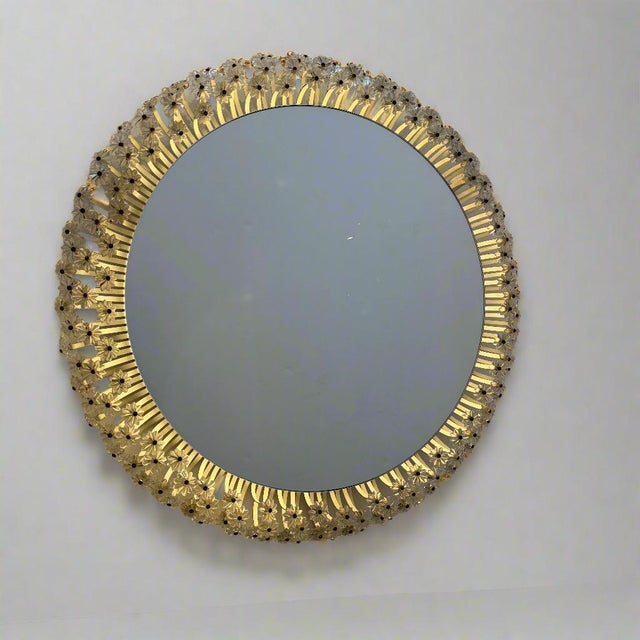A back-lit Modernist circular mirror surrounded by rows of illuminated lucite Rosettes.