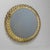 A back-lit Modernist circular mirror surrounded by rows of illuminated lucite Rosettes.