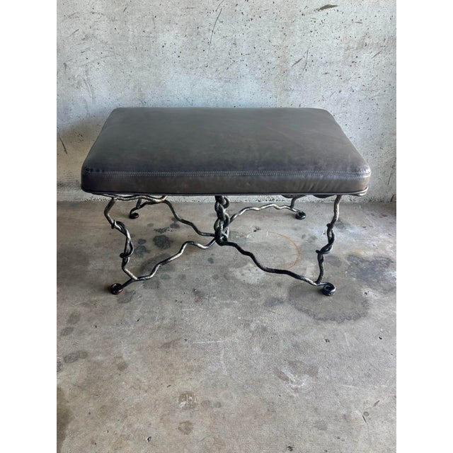 A striking mid-century bench featuring a hand forged hammered iron base with an organic branch-form structure. Four...