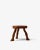 Small three-legged stool hand-carved from a single piece of solid wood. The irregular seat, cut from a tree section, shows...