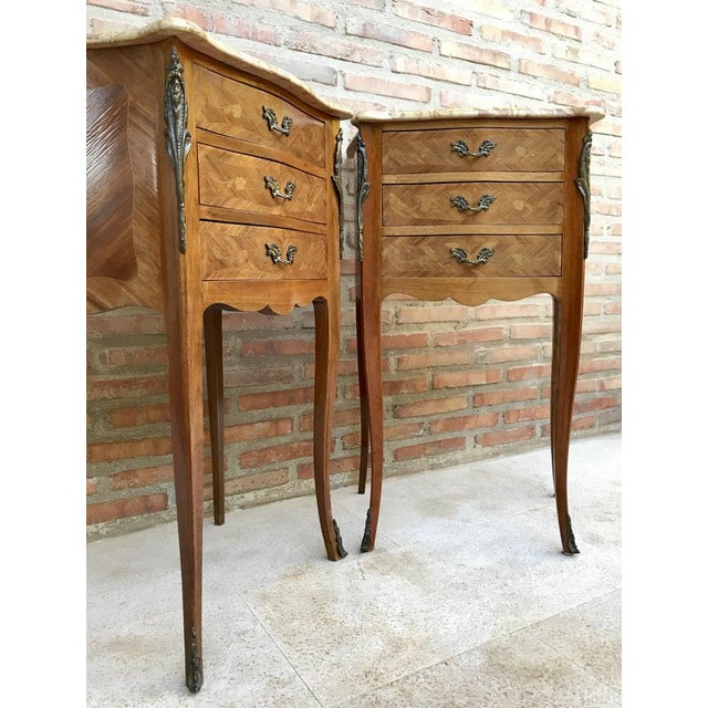 Pair of bedside tables or side tables or nightstands in French walnut with marquetry and marble top from the mid-20th...