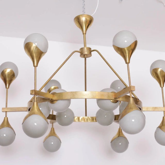 Stunning, very large Murano glass and brass chandelier attributed to Stilnovo. The chandelier has a very impressive size...