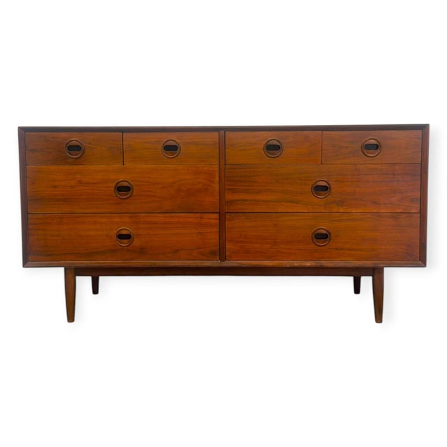 This mid-century modern style double dresser features a rich warm walnut finish, clean geometric lines, and iconic...