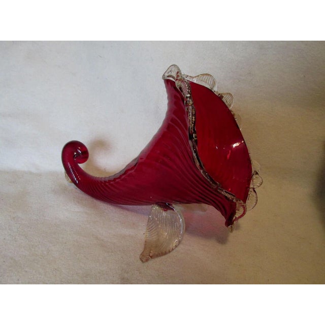 A Vintage Mid Century Modern Italian, Venetian Glass Cornucopia. The Cornucopia is hand blown glass with a ruby red body...