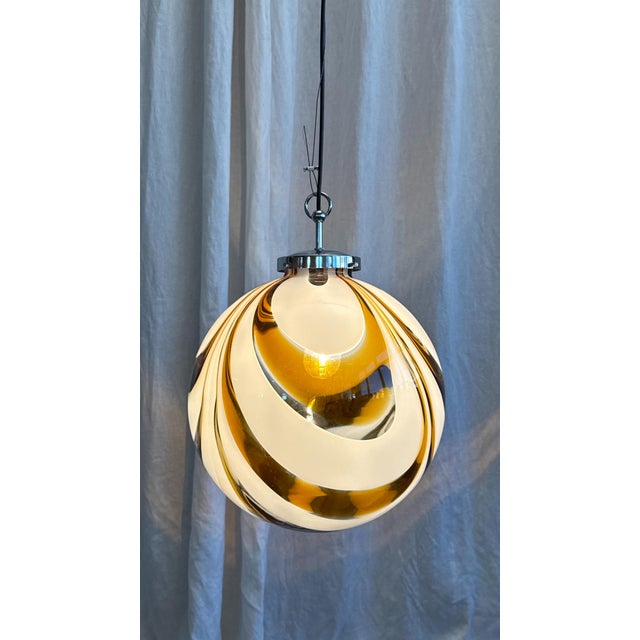 Beautiful Italian spherical Murano glass pendant with amber-white swirl pattern and chrome suspension, attributed to...