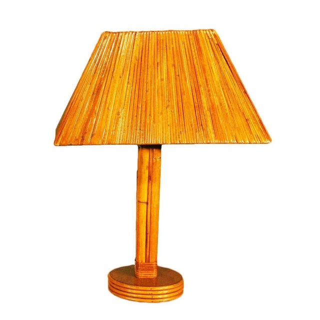 Pair of Four pole rattan lamps with brass nailhead accents are circa the 1950s. These lamps include Rare lamp shades...