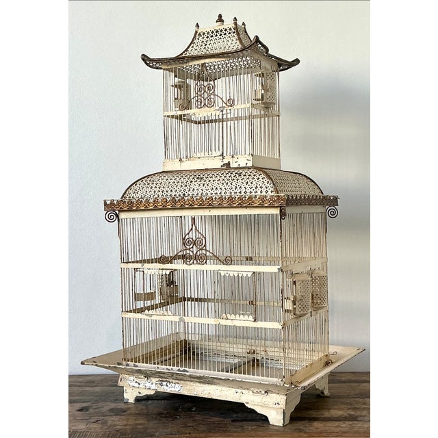 This vintage Chinoiserie-style metal birdcage is a captivating decorative piece, distinguished by its elegant pagoda-...