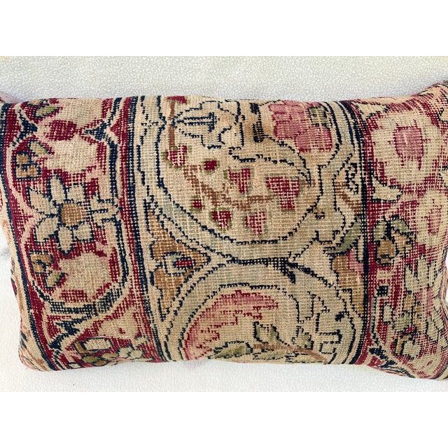 Decorative pillow upholstered in a 19th century Kerman rug fragment, featuring charming floral flowerhead motifs and an...