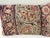 Decorative pillow upholstered in a 19th century Kerman rug fragment, featuring charming floral flowerhead motifs and an...