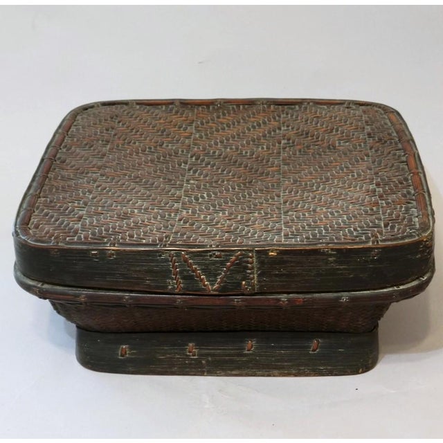 A beautifully crafted mid-20th century Philippine Ifugao basket woven from reed and bamboo and finished with a rich smoked...