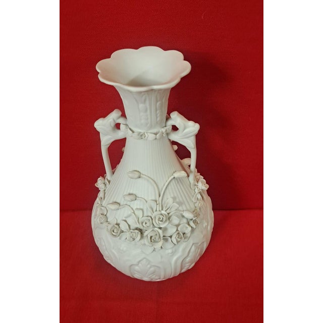 Beautiful biscuit vase with elaborate embossed floral decoration. It has two handles. Elegant and classic style, with...