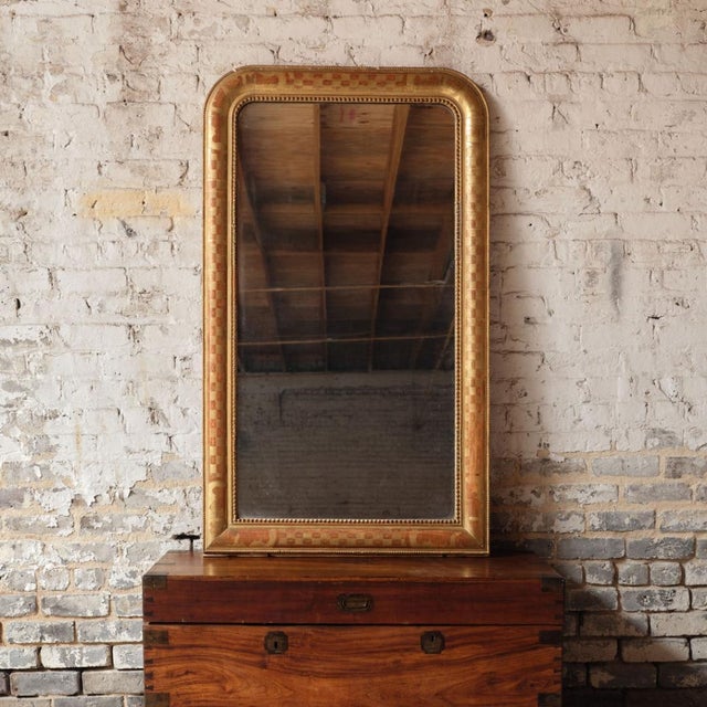 Enhance your space with the understated elegance of this 19th century French Louis Philippe mirror, a timeless antique...