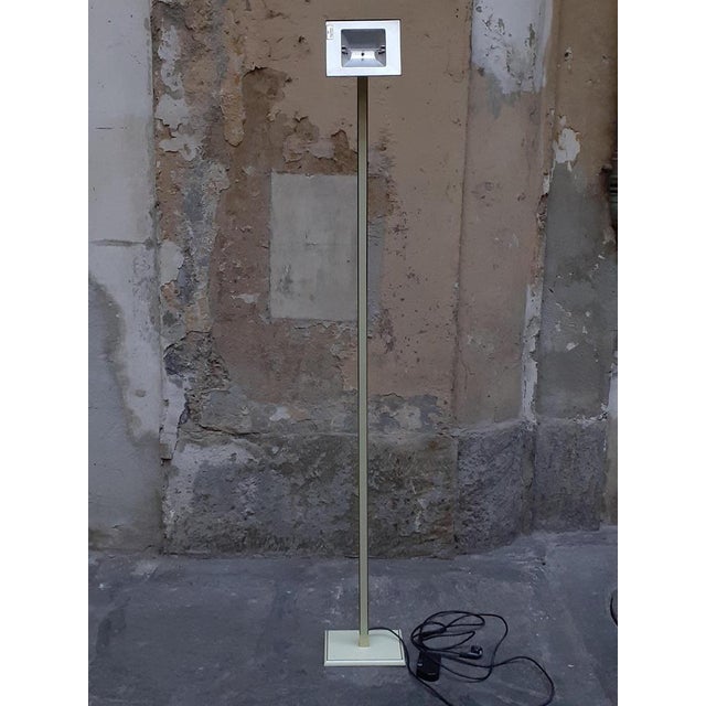 A brass lamp with white lacquered parts. The whole makes it very elegant, Italian manufacture, 1970s era. The lamp has an...