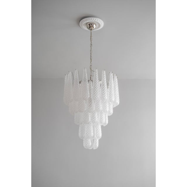 The chandelier has a new metal structure and wiring, on which petals made of Murano glass are suspended. The petals are...