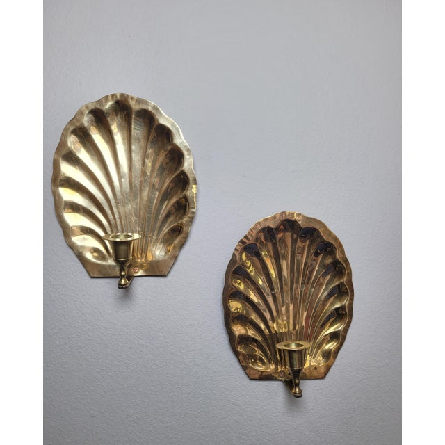 Elevate your wall decor with this striking pair of vintage solid brass candle sconces, masterfully cast in the shape of a...
