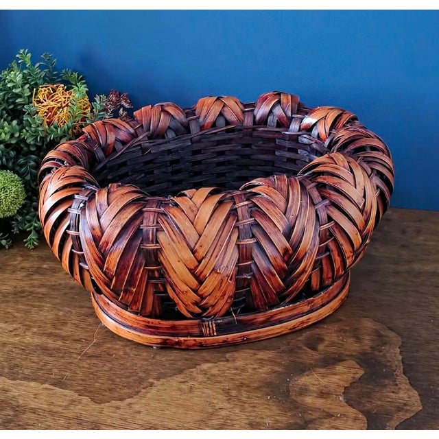 Exquisite antique Japanese Ikebana basket, finely handwoven from natural bamboo with a dramatic braided rim and deep...