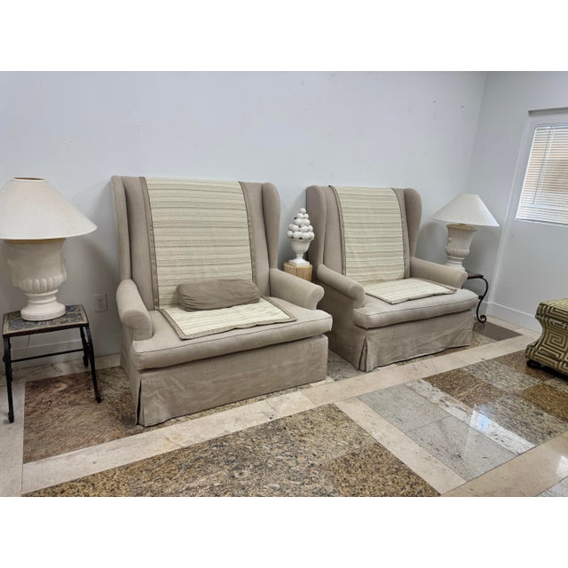 Beautiful pair of high back loveseats by Gregorius Pineo, labeled underneath. Upholstered in a soft oatmeal linen with...