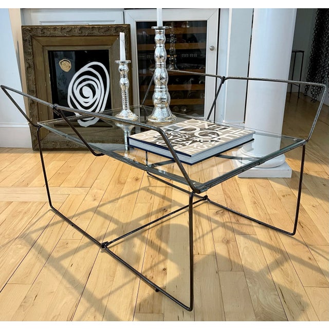 Industrial modern coffee table is sleek and elegant. The slender metal legs perfectly augment the fresh glass table top....