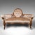 This is an antique carved spoon back settee. An English, walnut and Chenille upholstered showpiece sofa, dating to the...