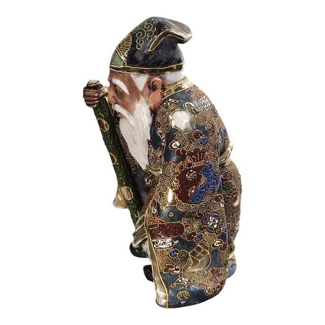 A substantial Japanese Kutani porcelain figure of Jurojin, dating to the Meiji period, circa 1880–1910. This seated figure...