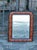 A small French Louis-Philippe style wooden mirror from the early 20th century, with tortoise style painted frame, brown...